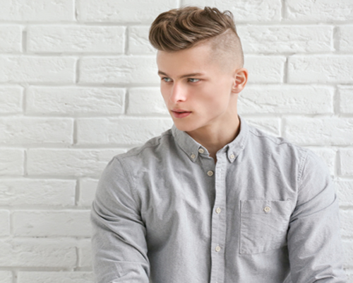 Handsome Young Man Posing on White Brick