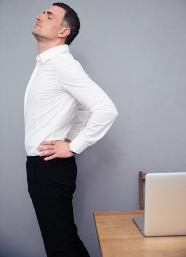 Businessman having backache in office