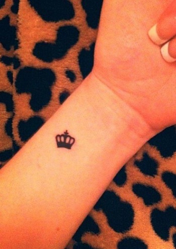 king symbol tattoo on wrist