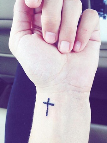 small cross tattoo on wrist