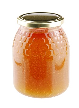 Homemade honey in a glass jar on white